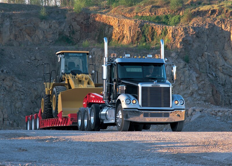 Freightliner truck hauling bulldozer