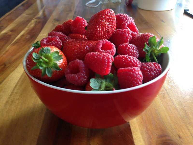 fresh berries in a red bowl