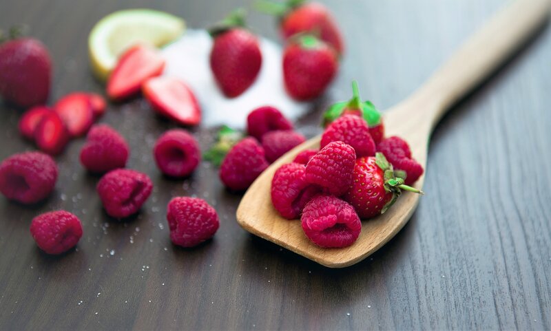 Fresh berries on a wooden spoon