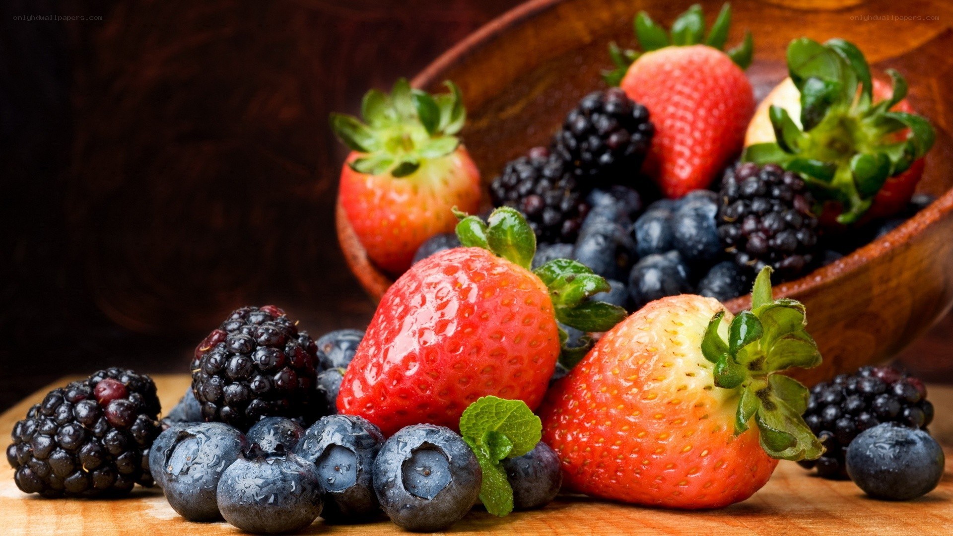 fresh berries on wooden surface