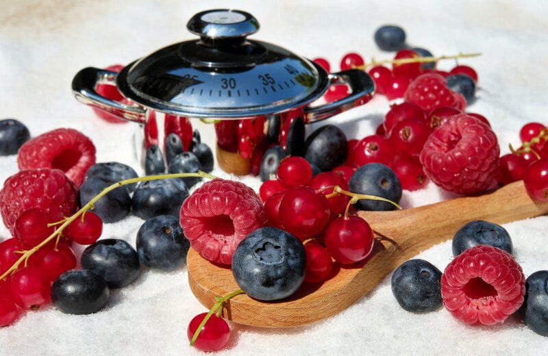 Fresh berries with kitchen scale