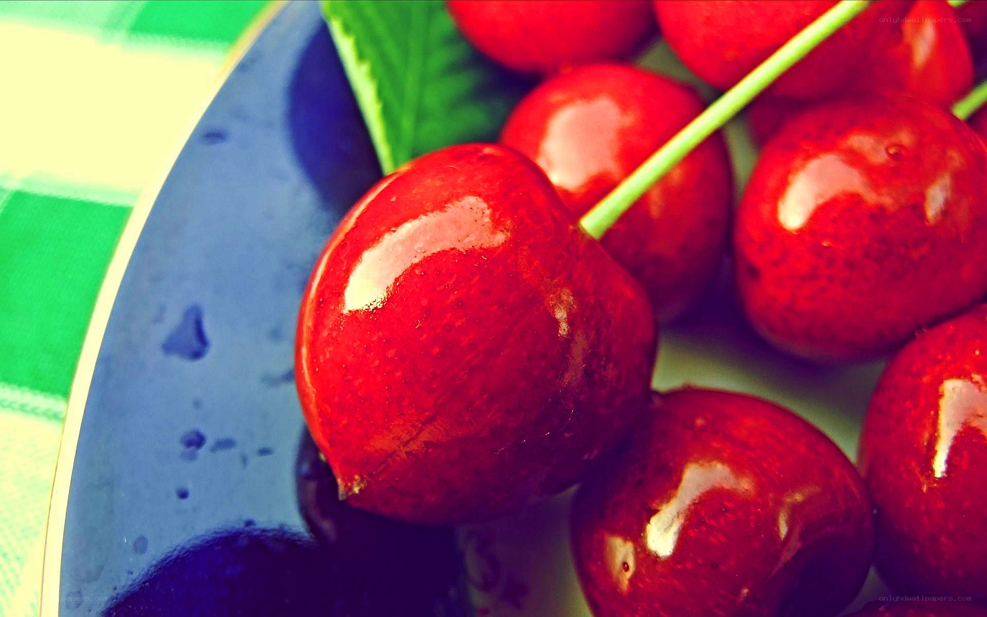 Fresh cherries on a blue plate