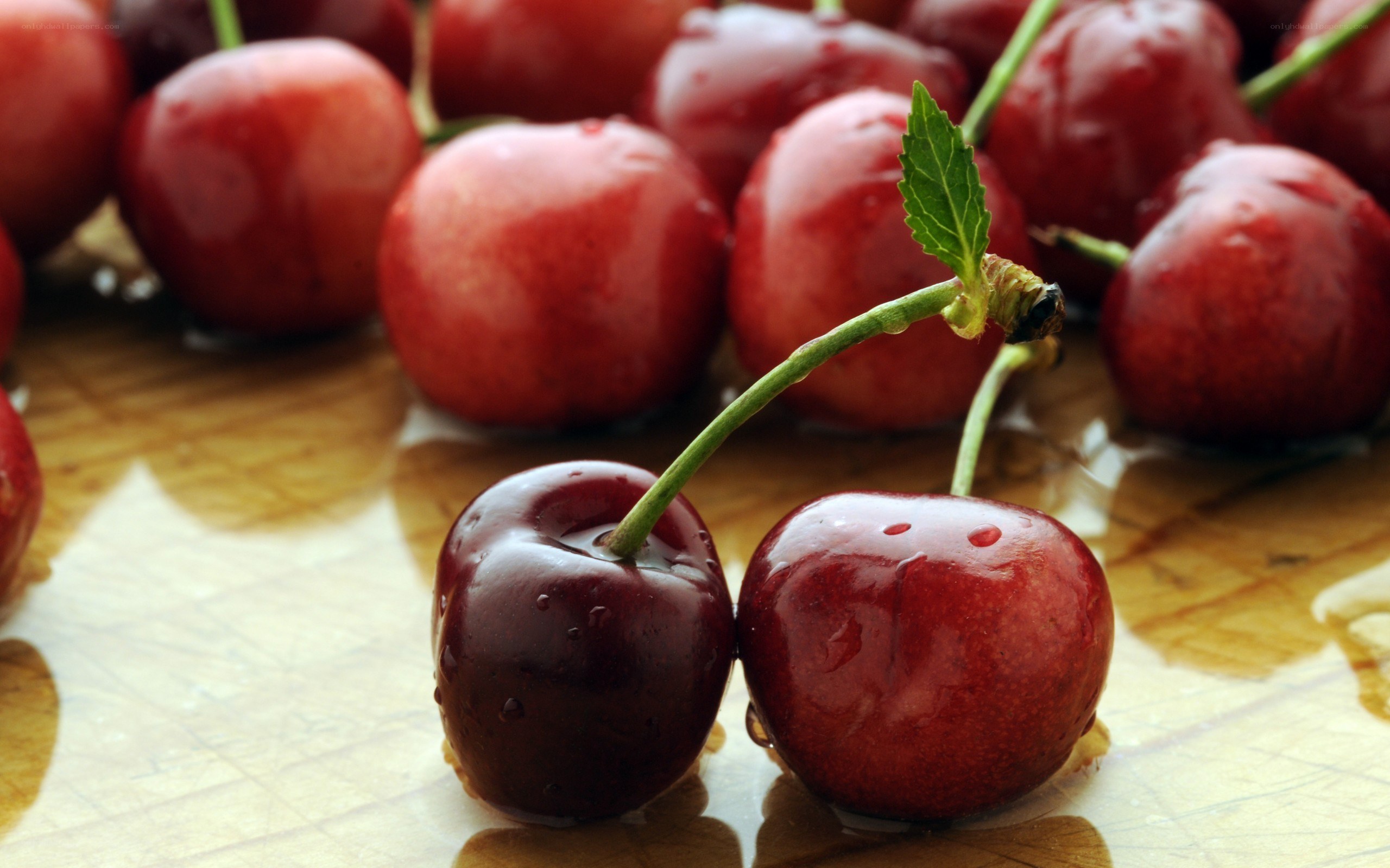 fresh cherries on wooden surface