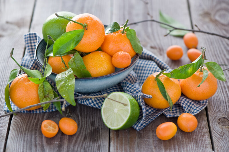 Fresh citrus fruits on wood