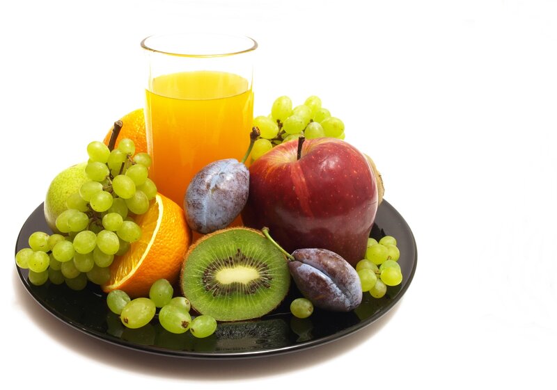 Fresh fruit and juice on a plate