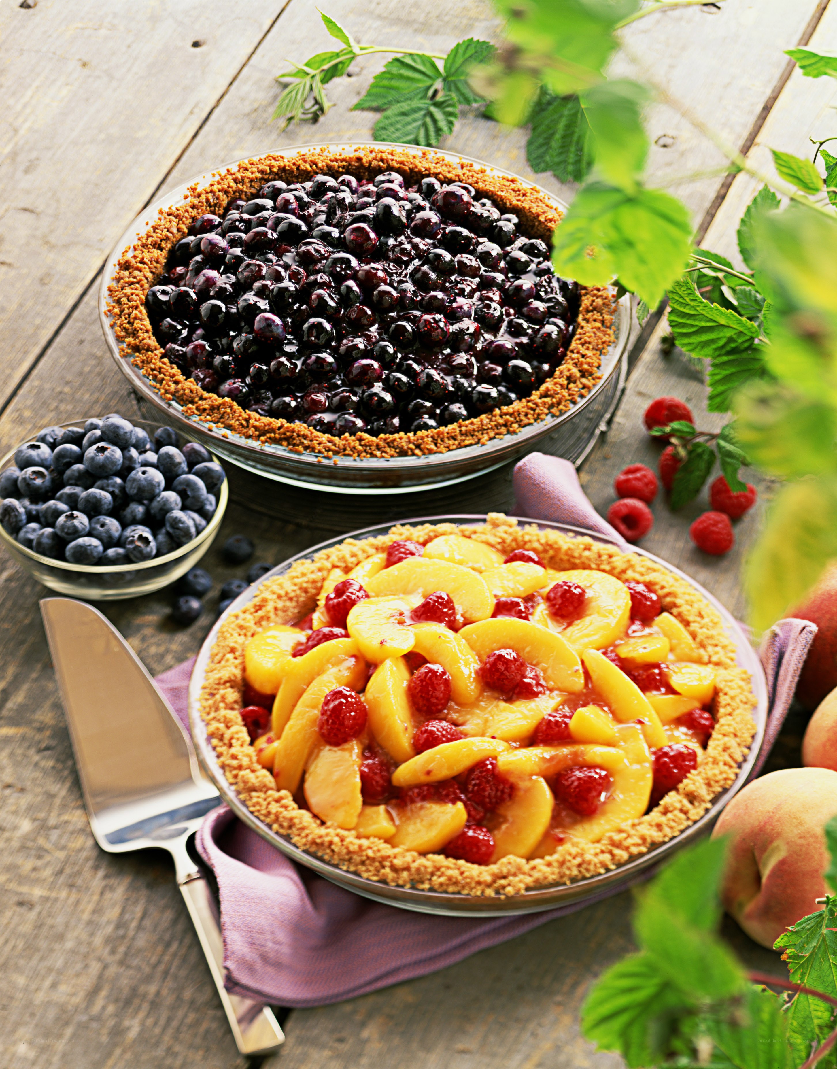 Fresh fruit pies on wooden table