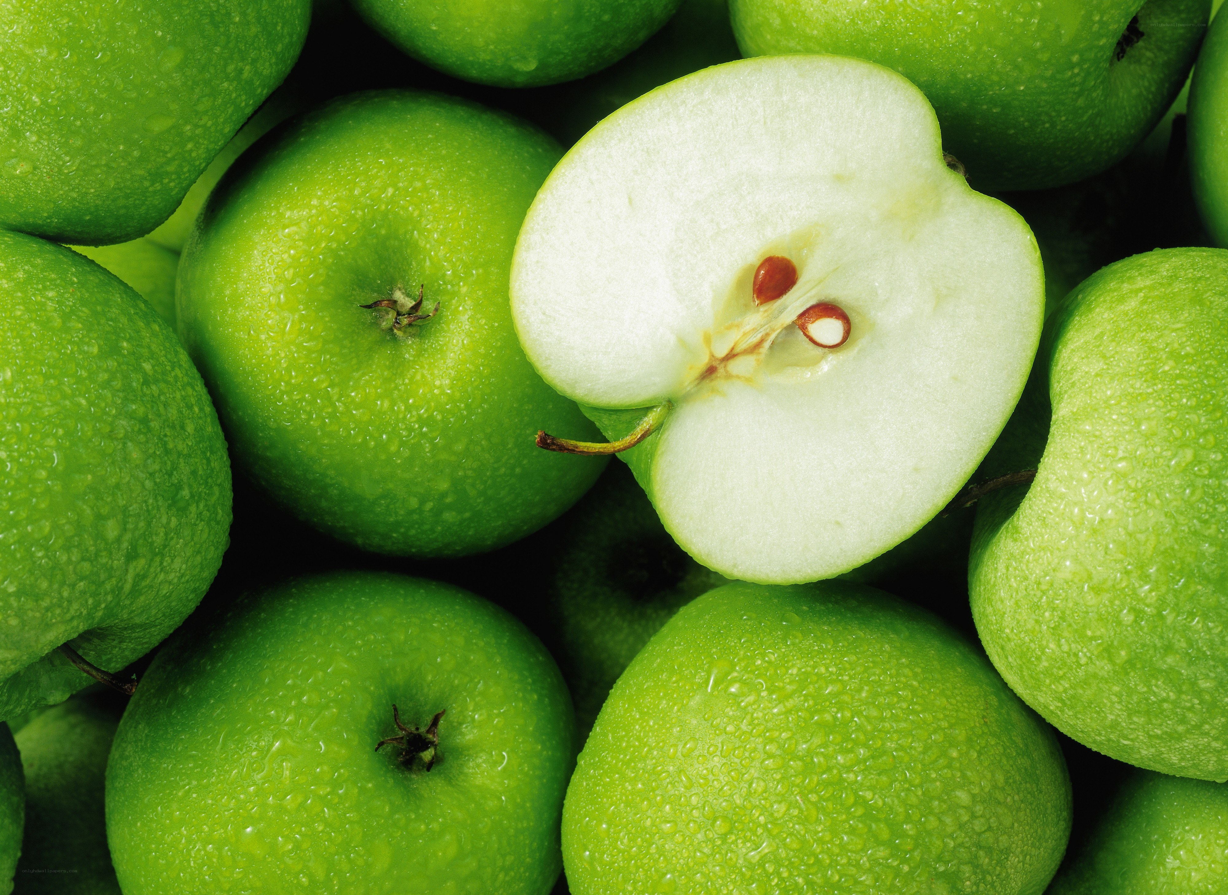 Fresh green apples with one cut