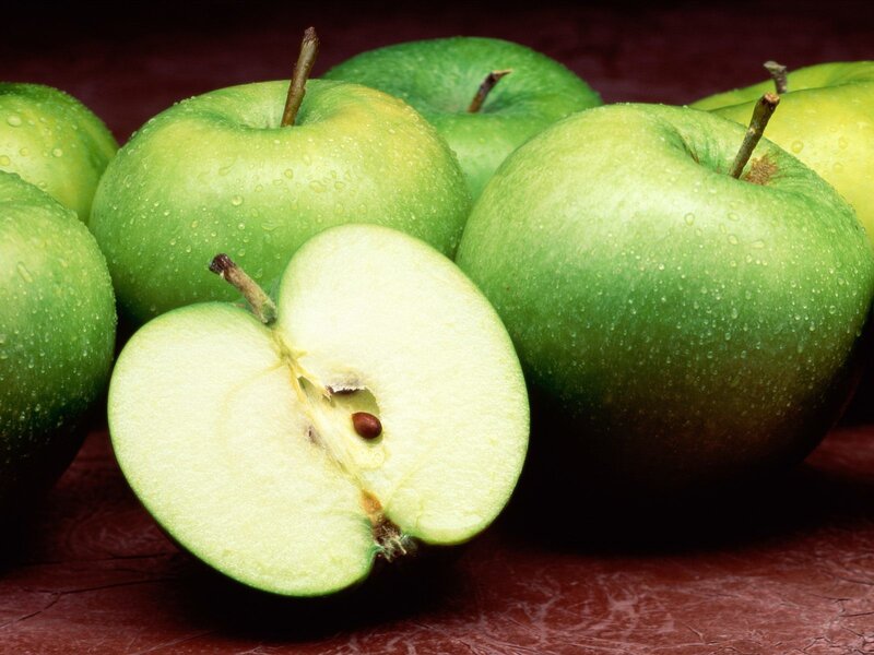 Fresh green apples with one cut