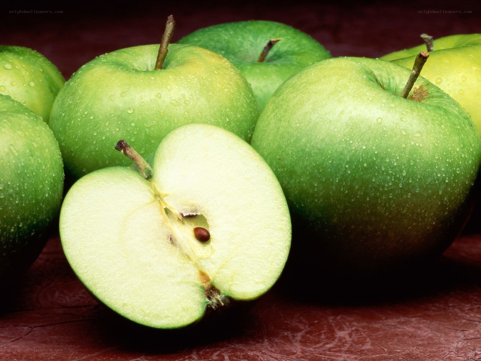 Fresh green apples with one cut
