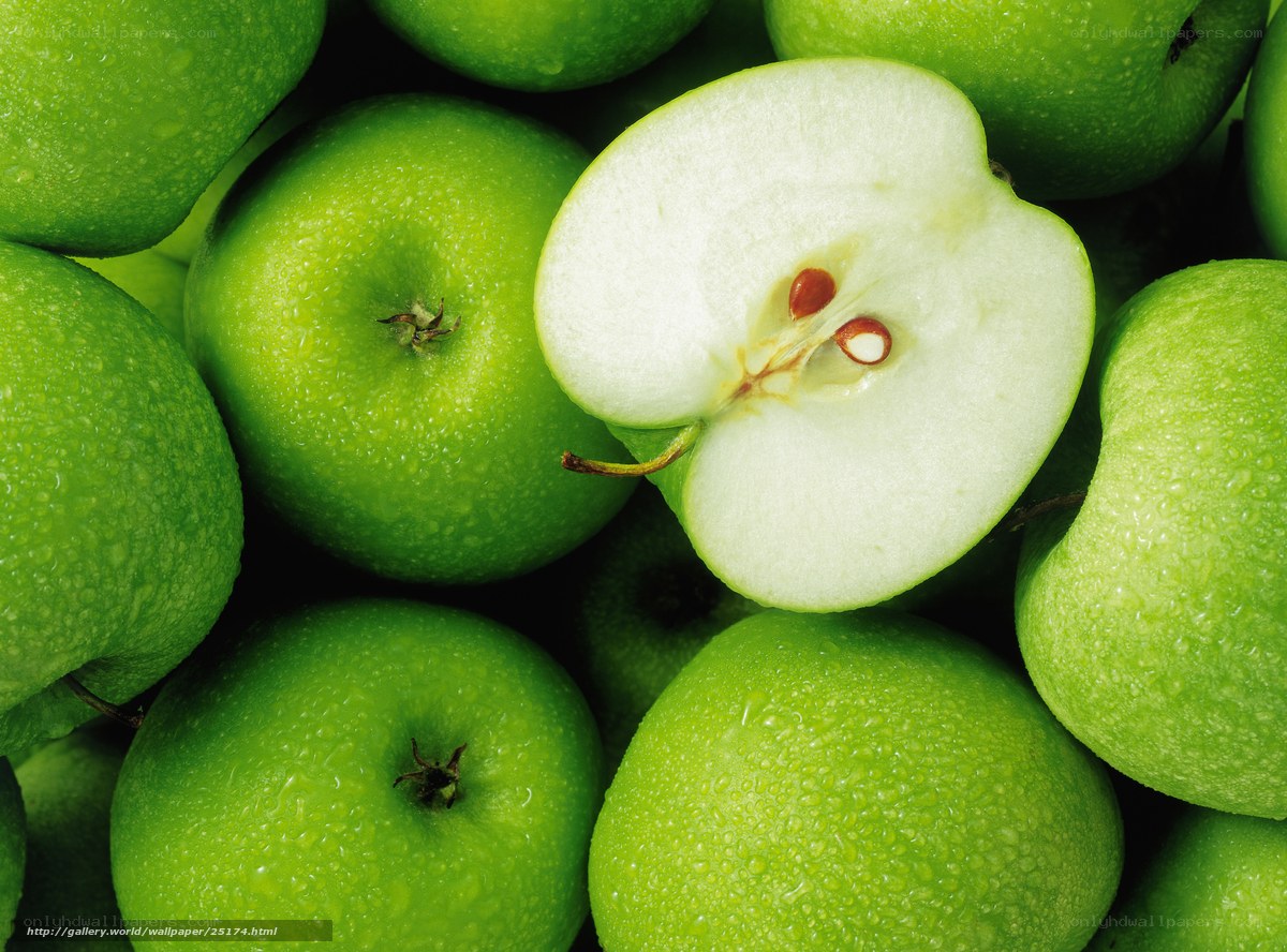 Fresh green apples with one sliced
