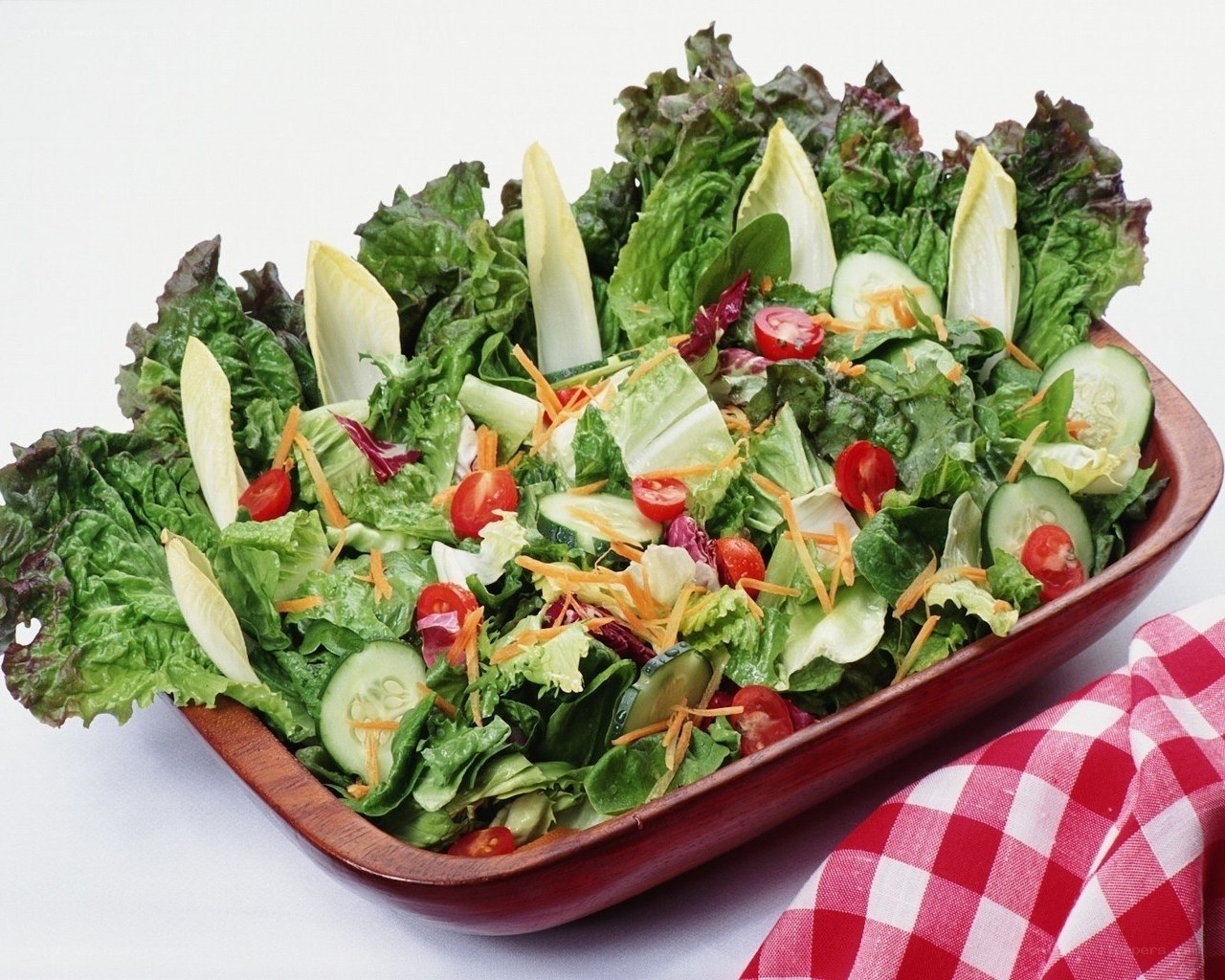 fresh green salad in wooden bowl