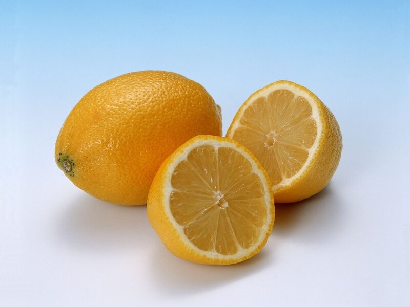 Fresh lemons on blue background