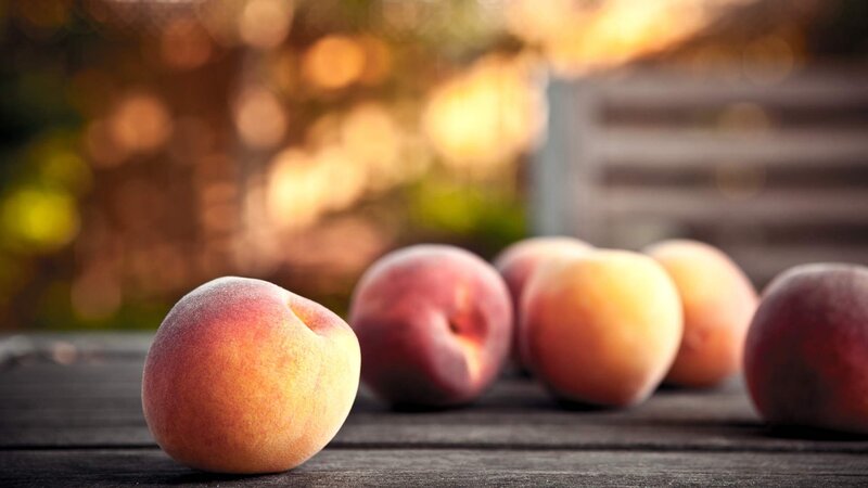 Fresh peaches on a wooden table