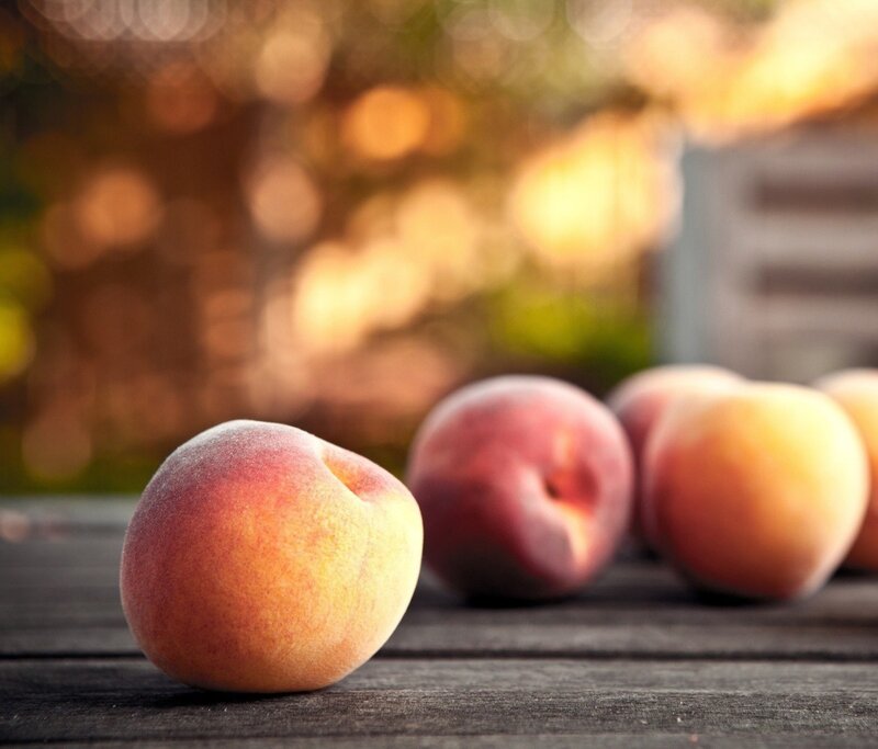 fresh peaches on wooden table