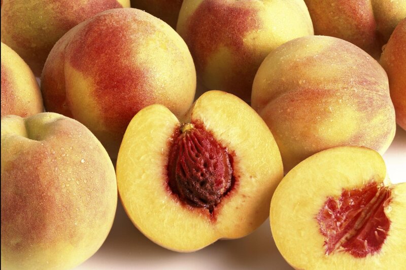 Fresh peaches with one cut in half