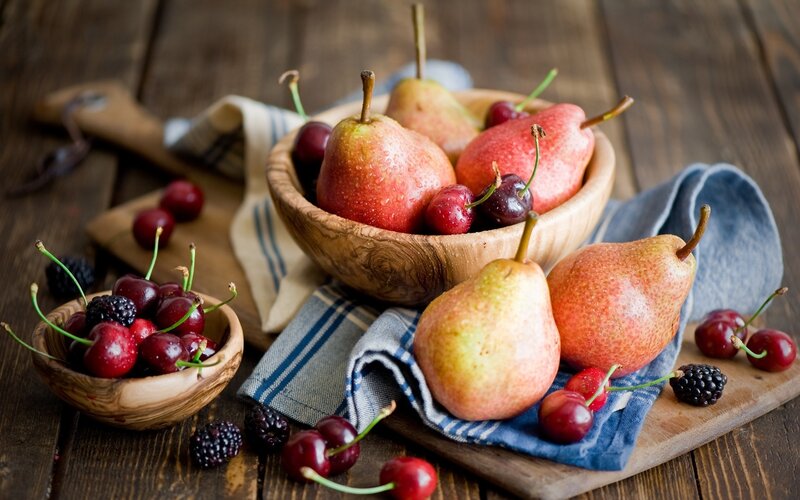 Fresh pears and cherries on wood
