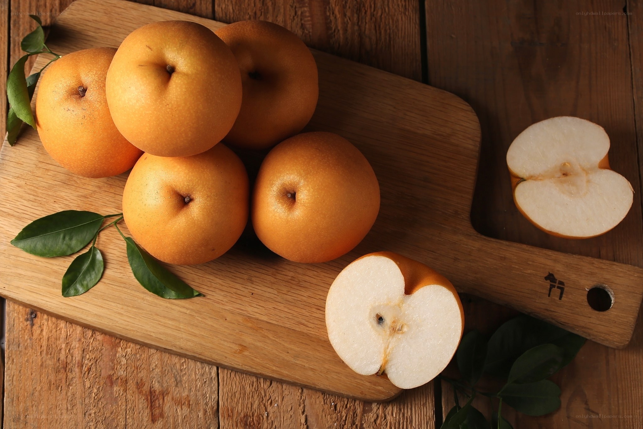 Fresh pears on a wooden board