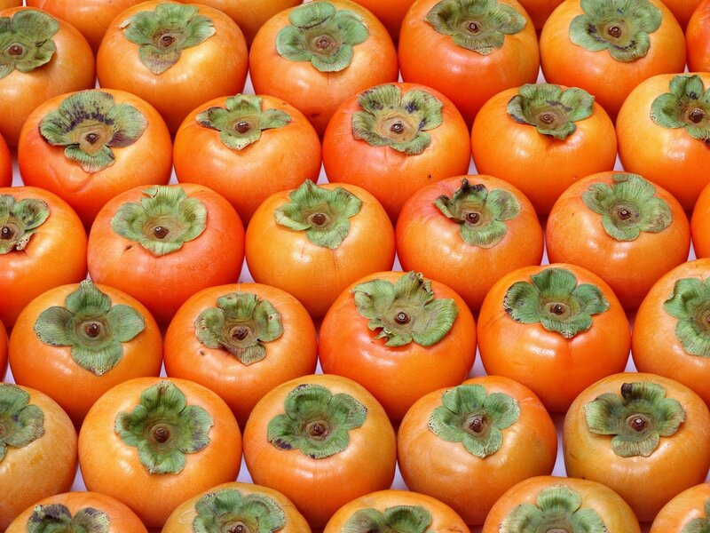 Fresh persimmons in a pile