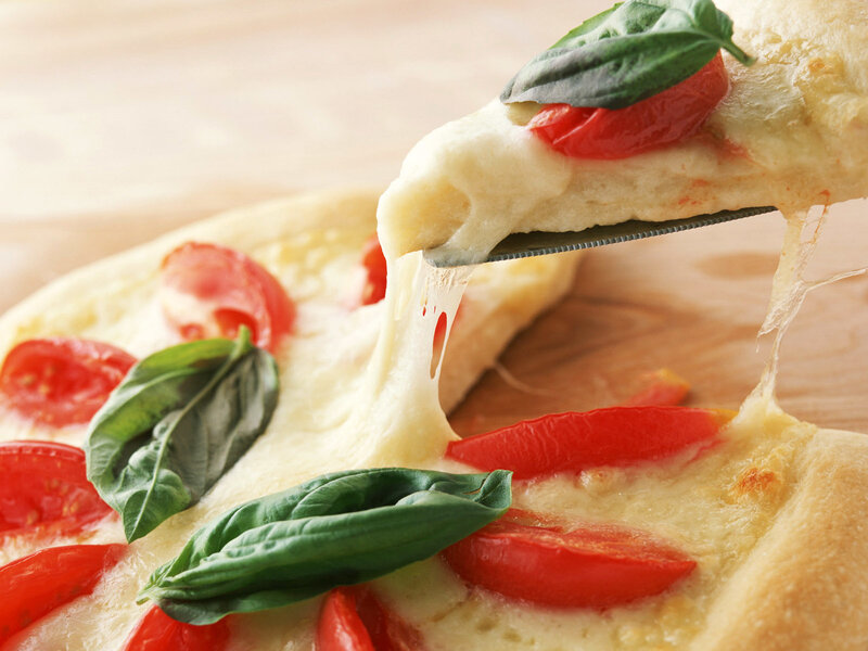 Fresh pizza with basil and tomatoes