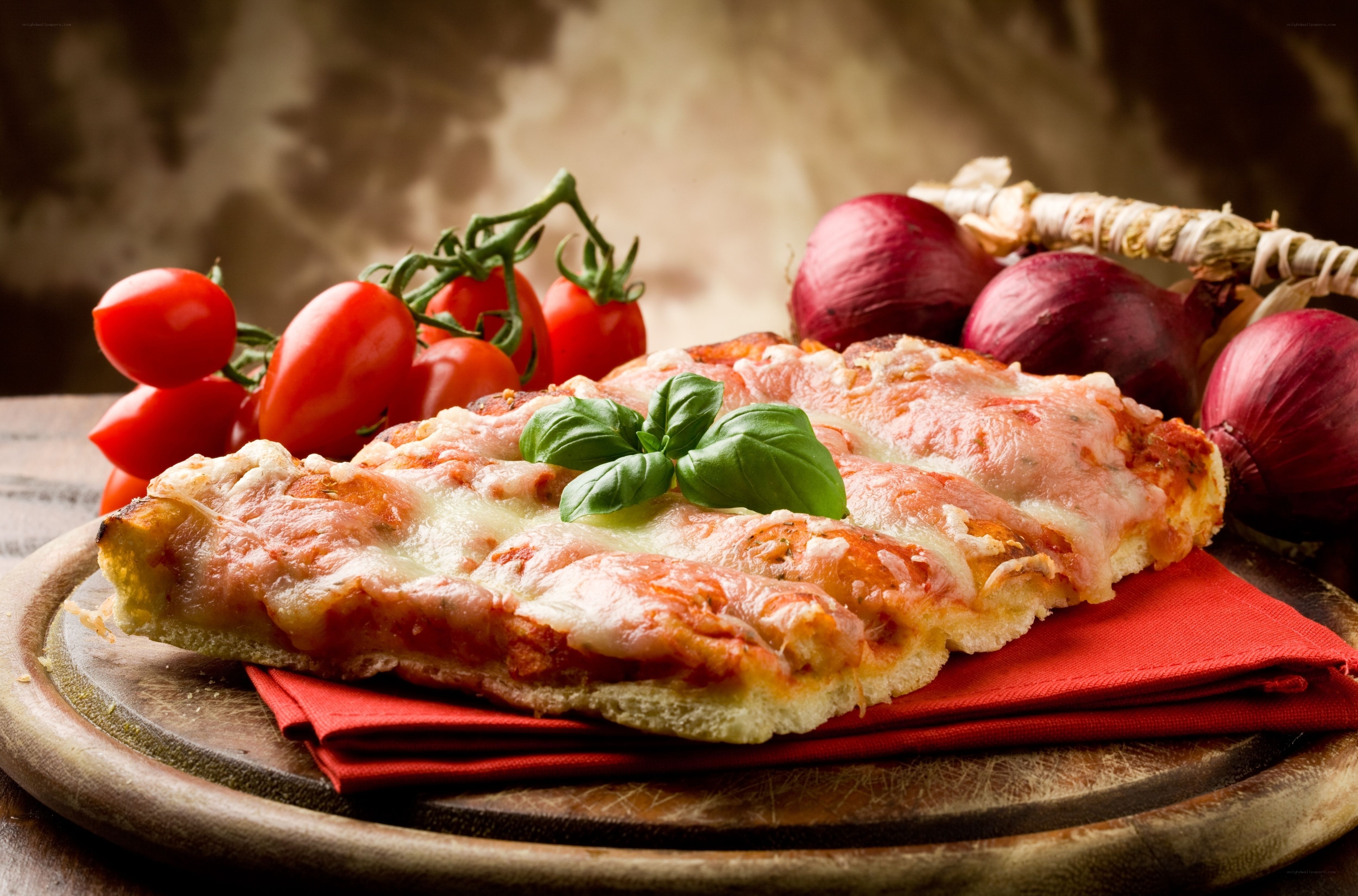 Fresh pizza with basil and tomatoes