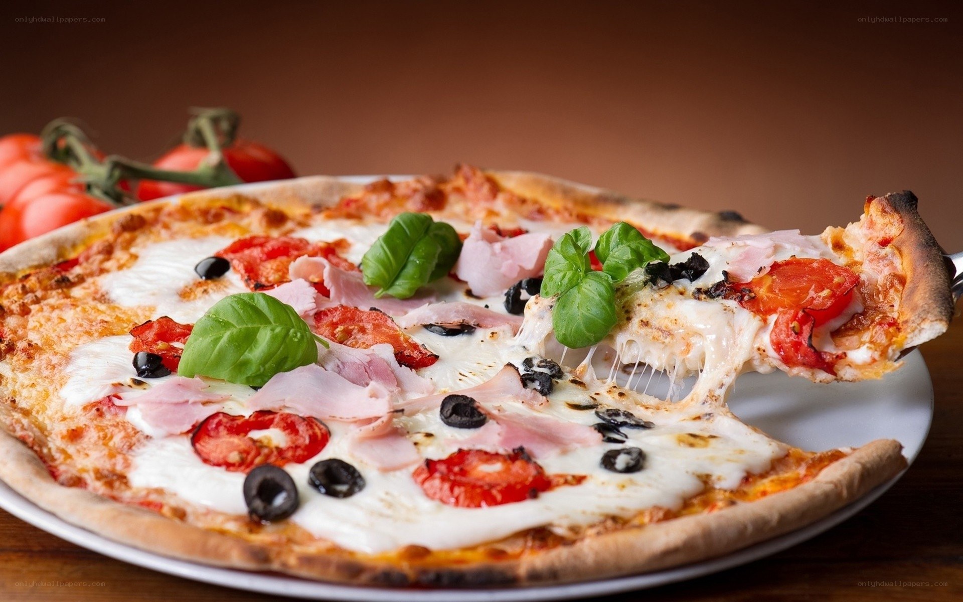 Fresh pizza with ham and basil