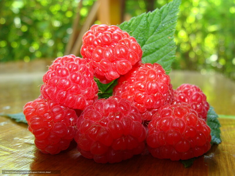 Fresh raspberries on a wooden surface