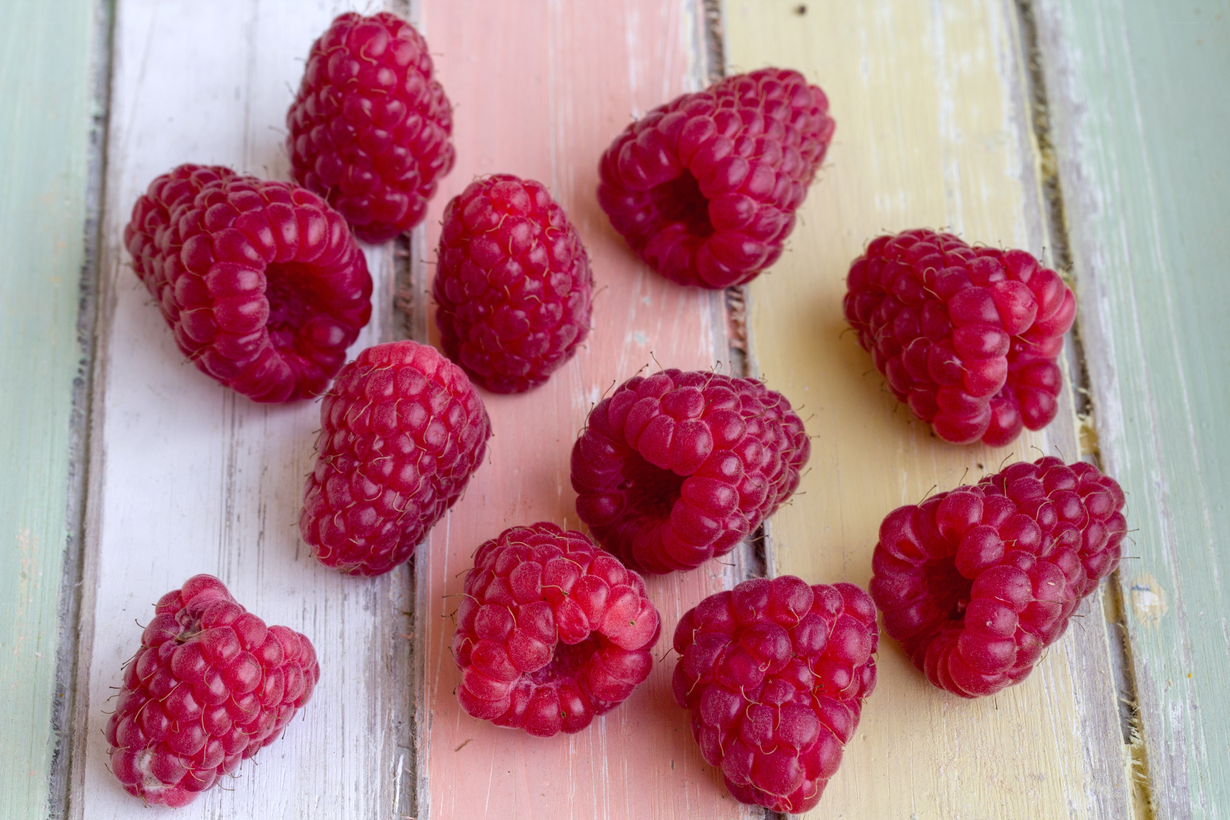 Fresh raspberries on wooden surface
