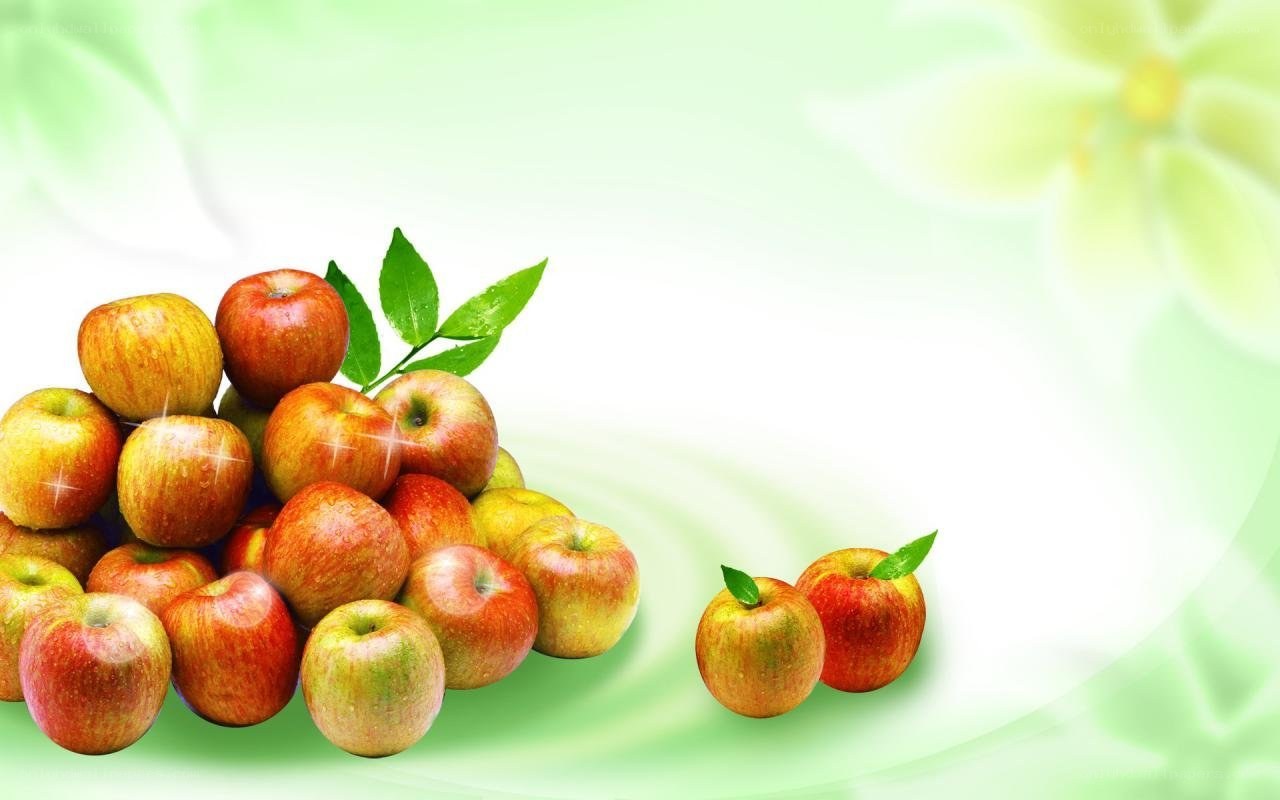 Fresh red apples on green background