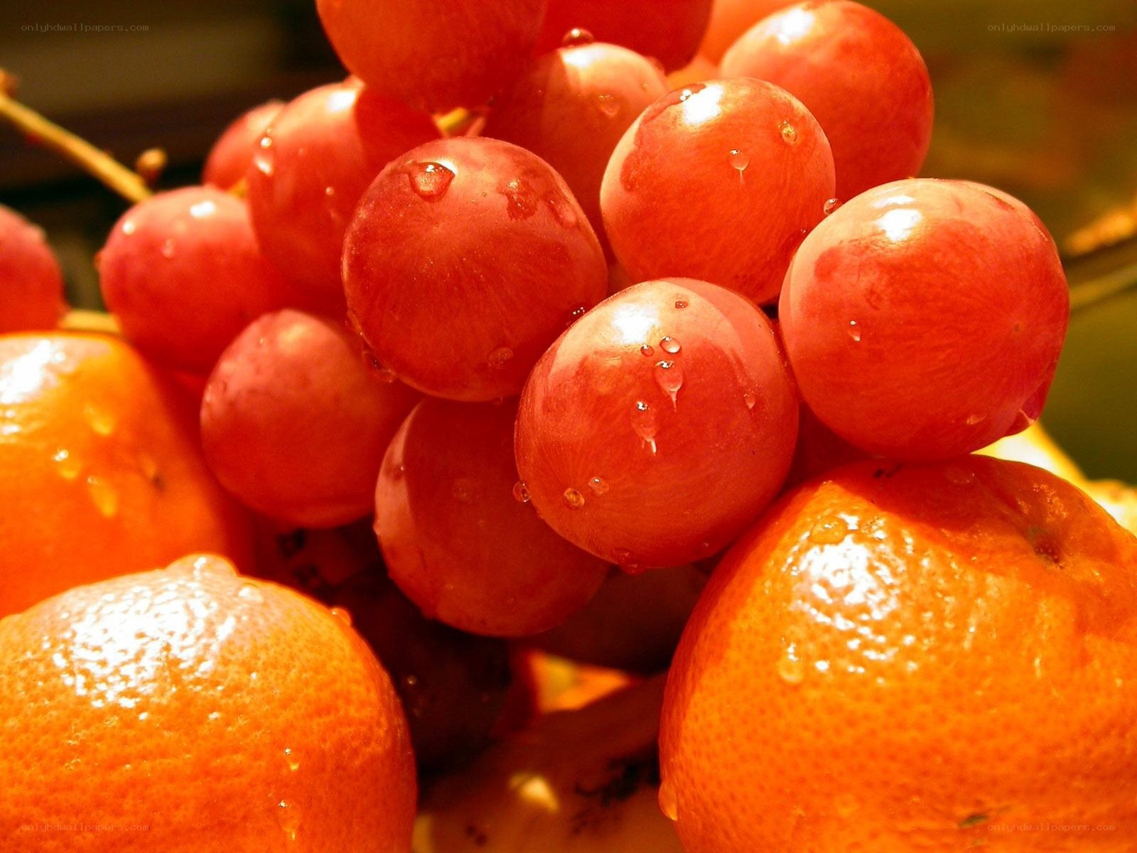 Fresh red grapes and oranges