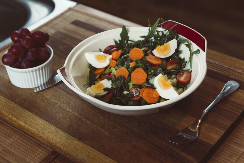Fresh salad with eggs and grapes