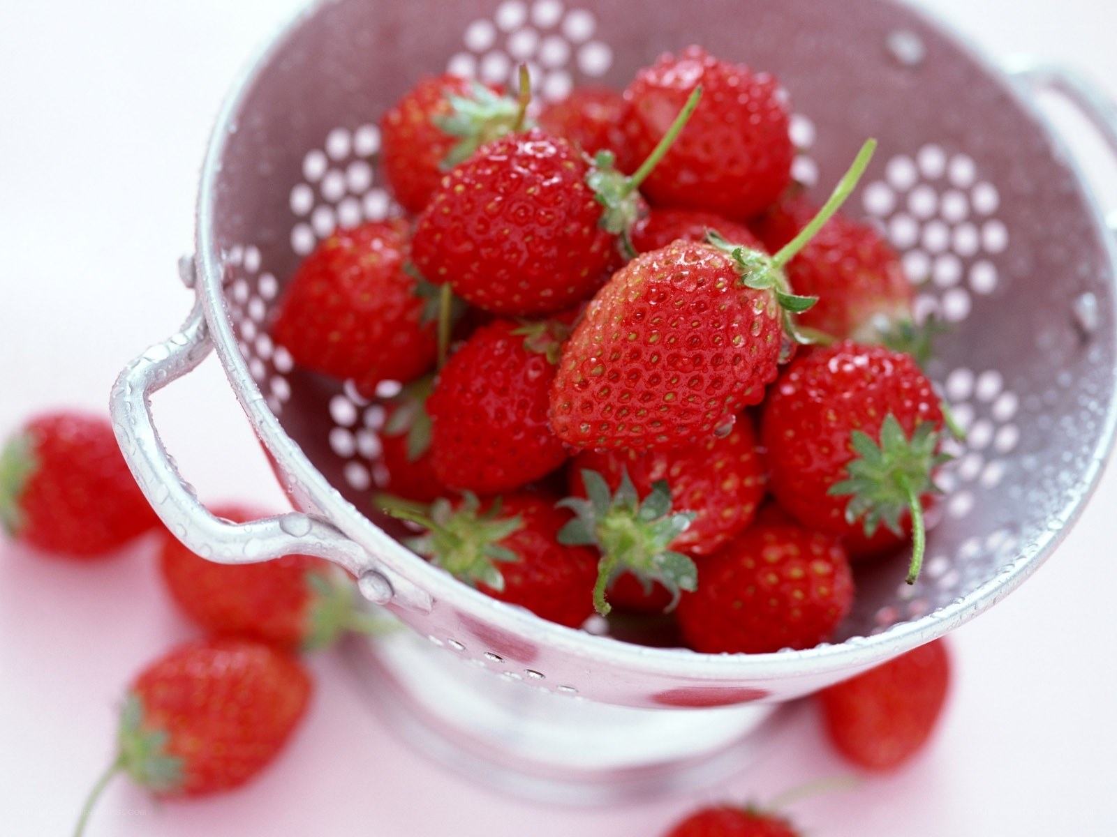 Fresh strawberries in a colander