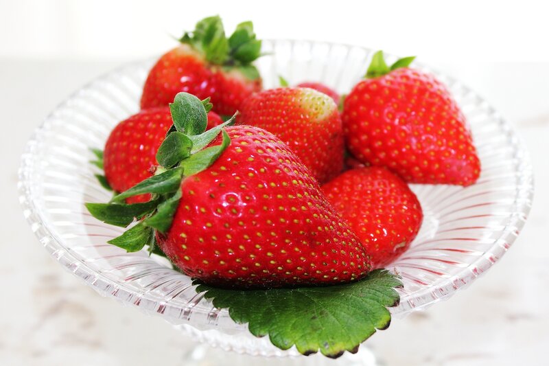 Fresh strawberries in a glass bowl