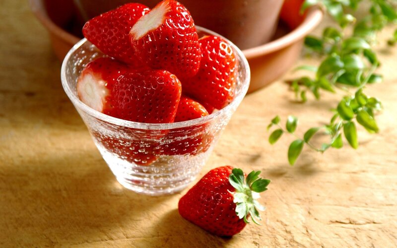 Fresh strawberries in a glass bowl