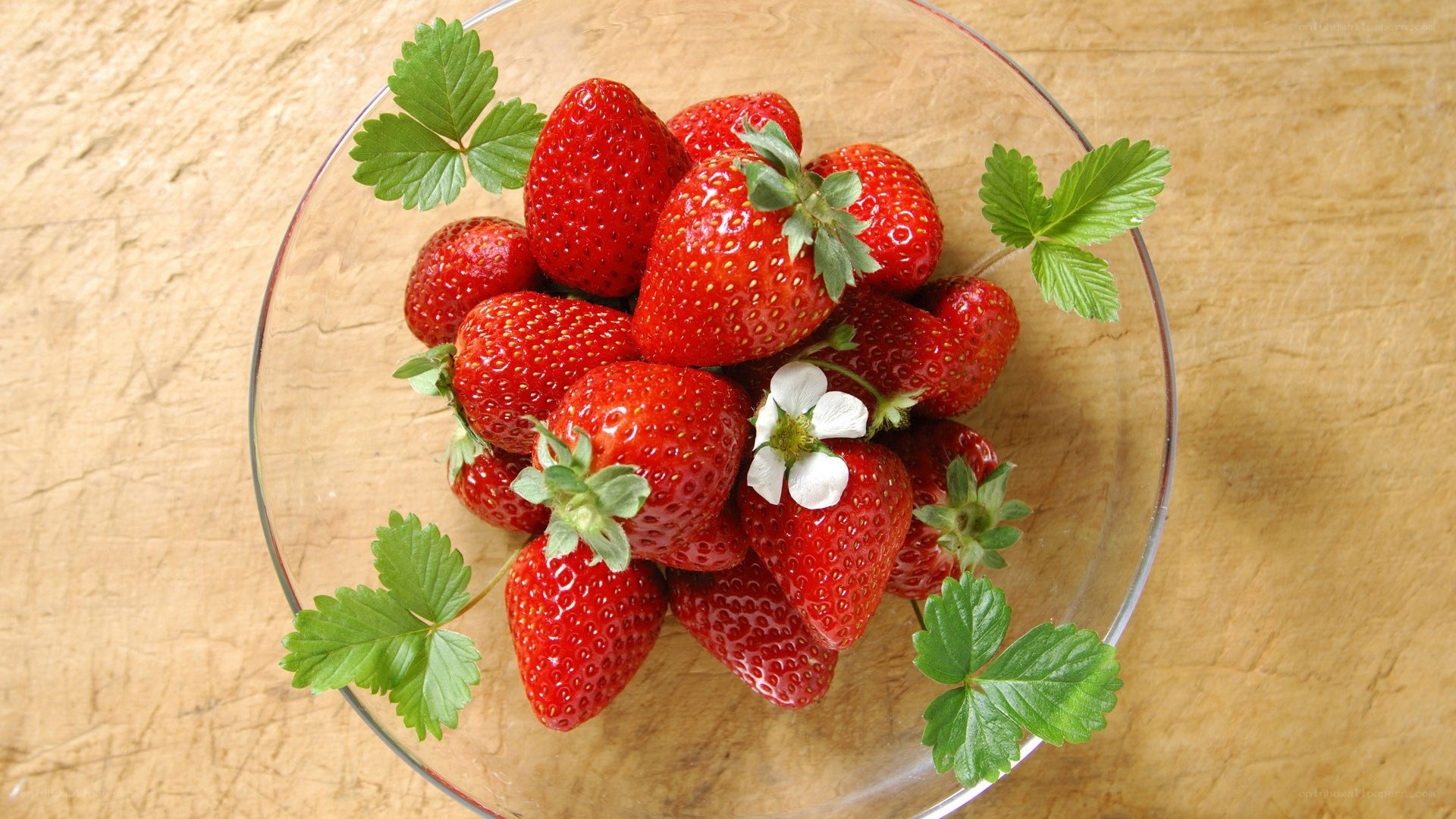Fresh strawberries in a glass bowl