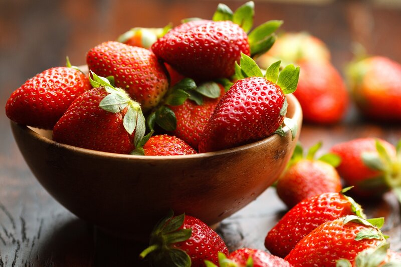 Fresh strawberries in a wooden bowl