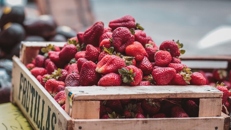 Fresh strawberries in a wooden crate
