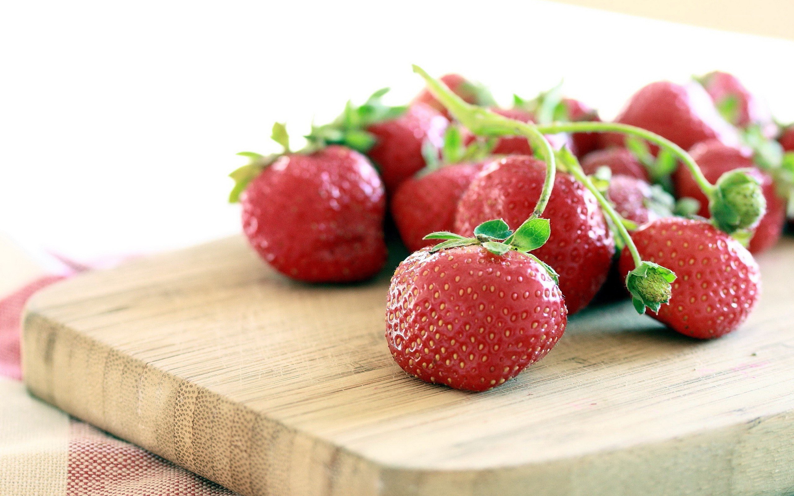Fresh strawberries on a cutting board