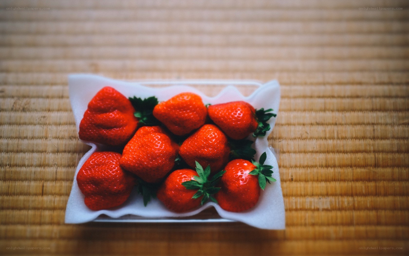 Fresh strawberries on a mat