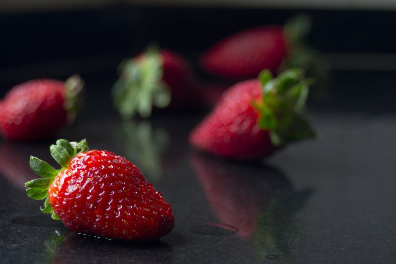 Fresh strawberries on dark surface