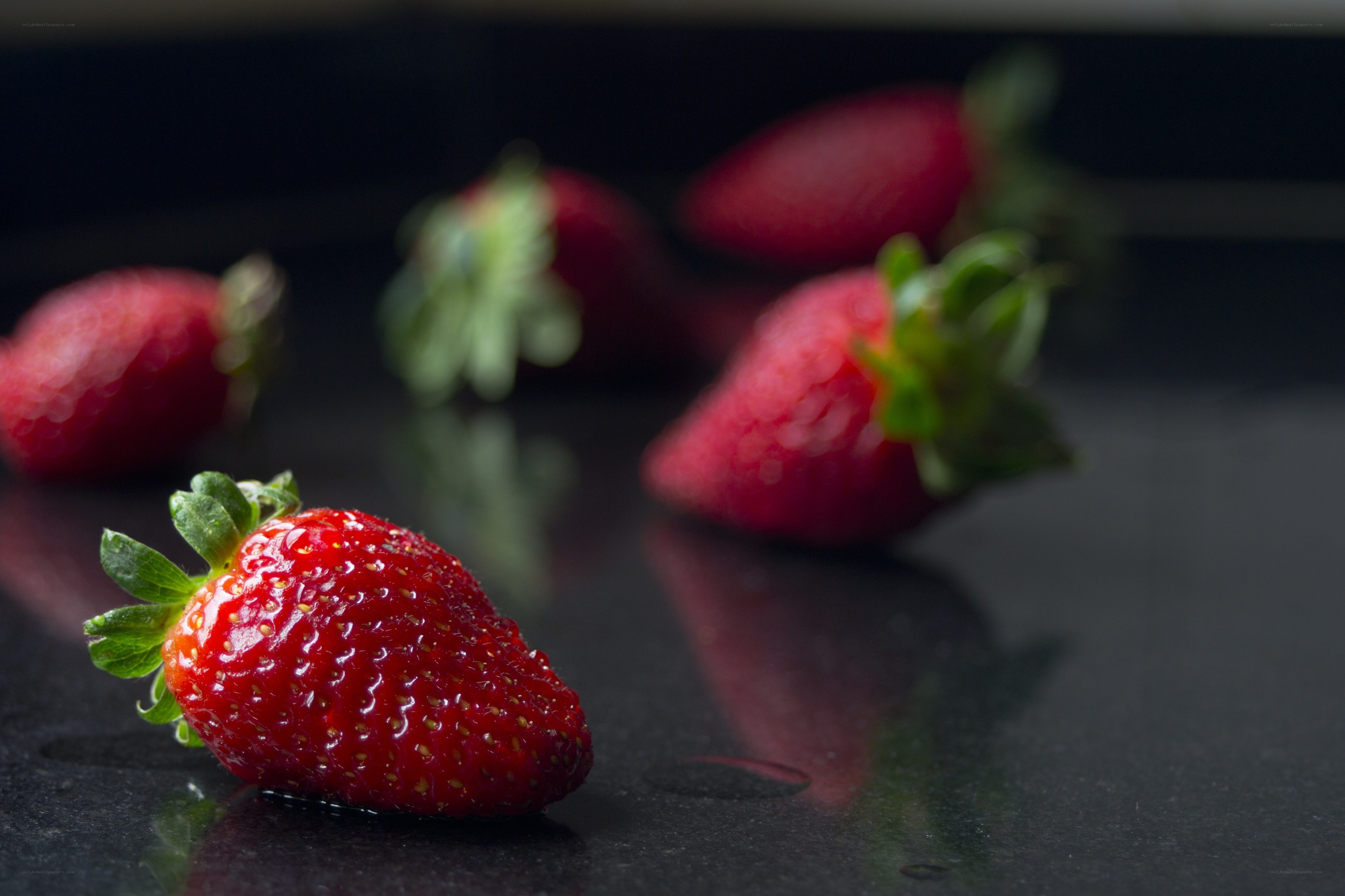 Fresh strawberries on dark surface