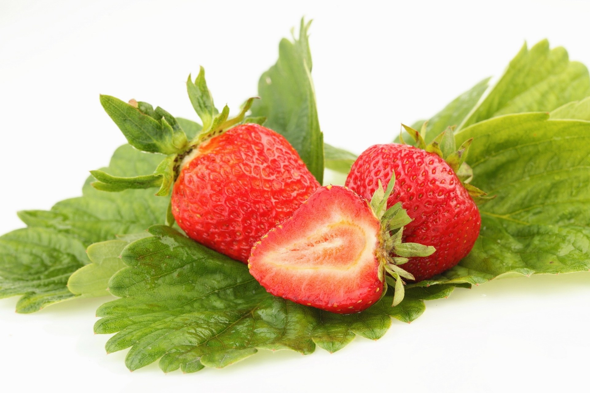 fresh strawberries on green leaves