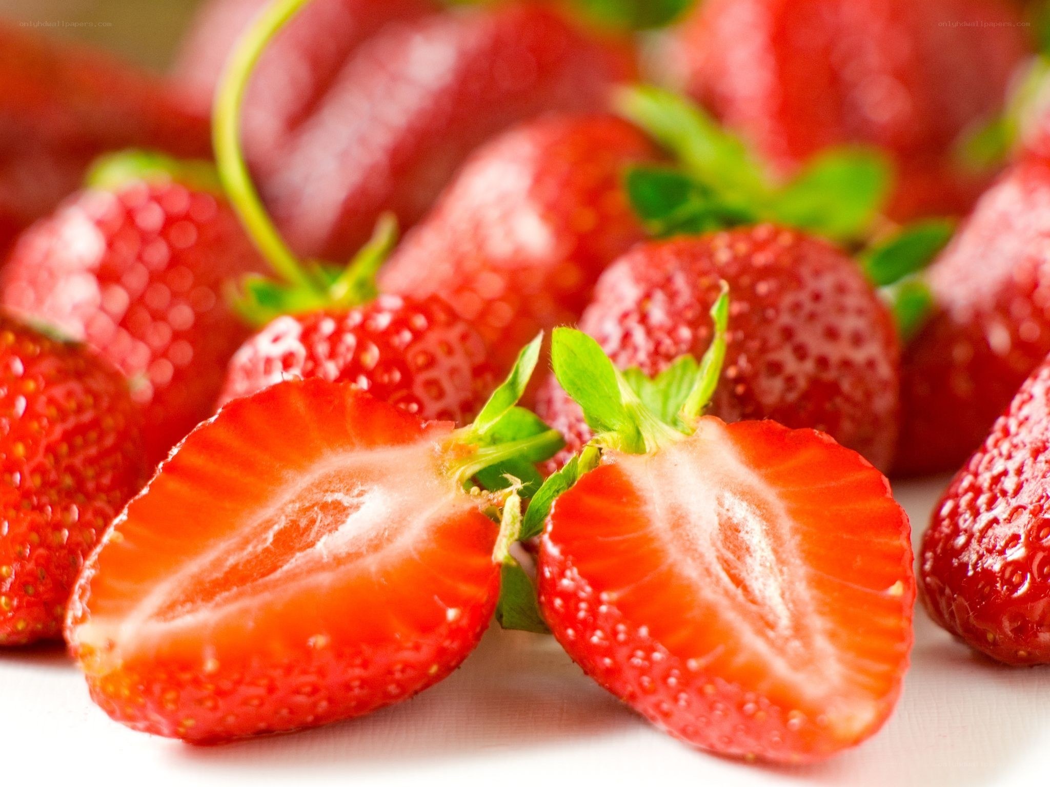 Fresh strawberries on white surface