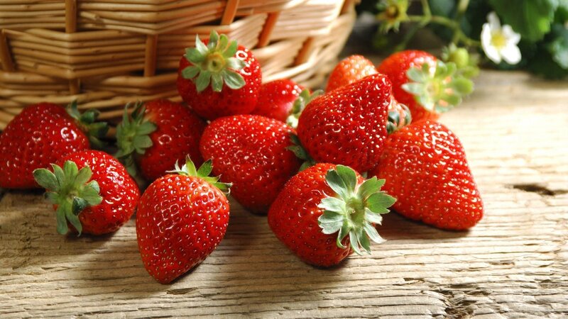 Fresh strawberries on wooden table