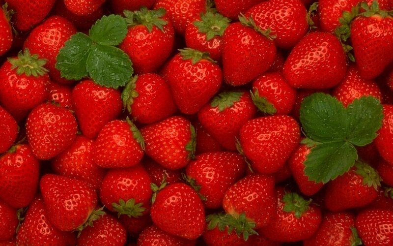 Fresh strawberries with green leaves