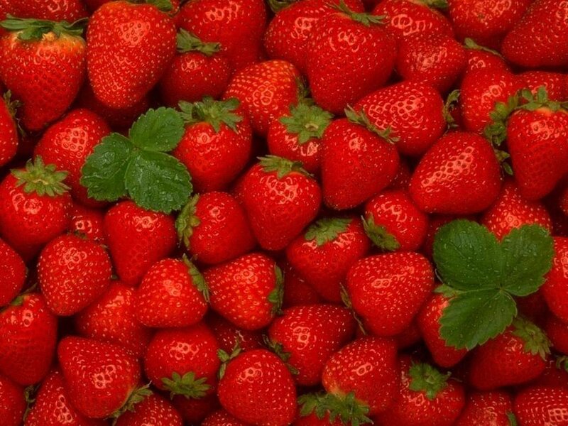 Fresh strawberries with green leaves