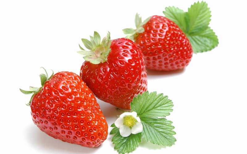 Fresh strawberries with leaves and flower
