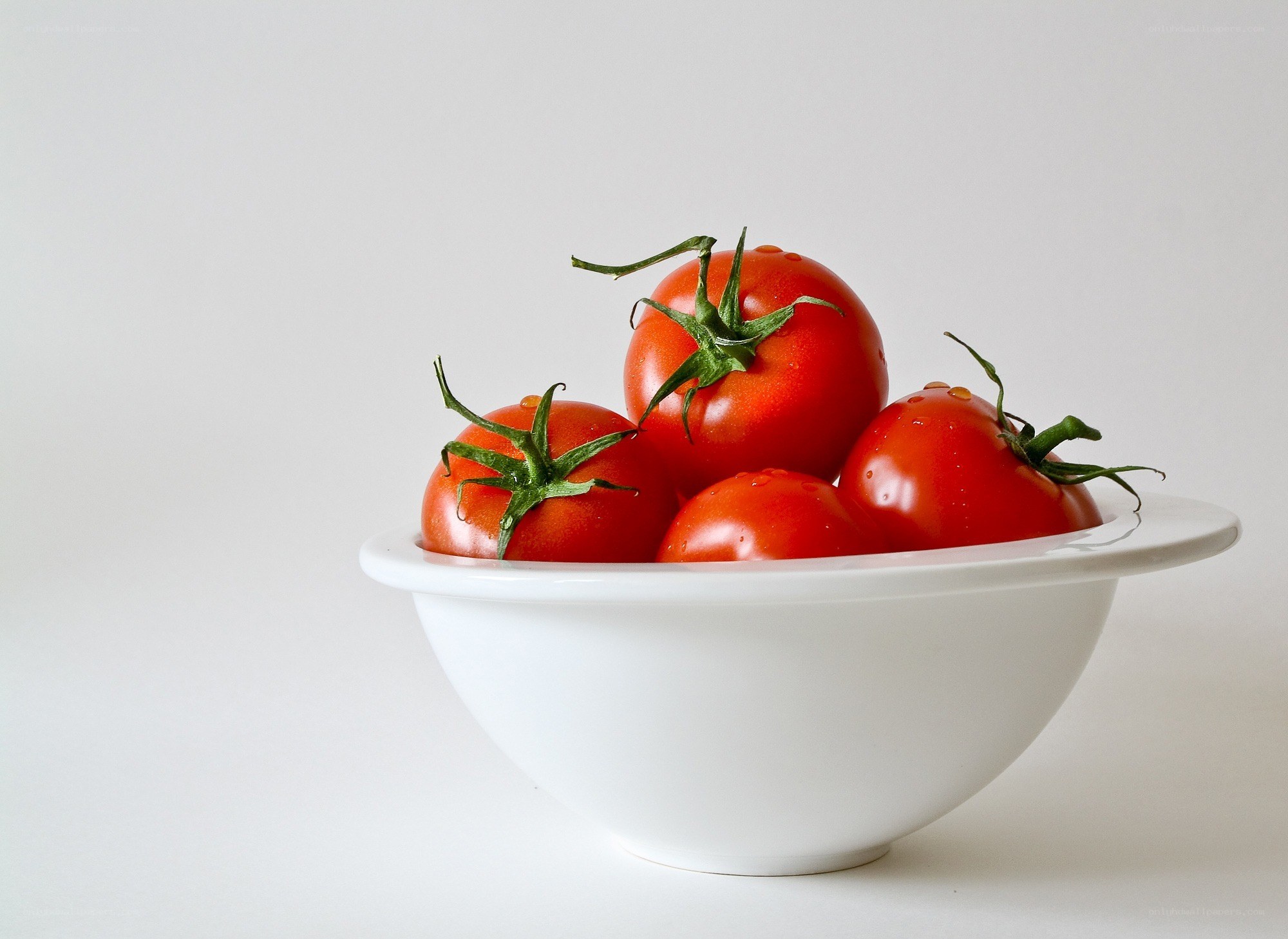 Fresh tomatoes in a white bowl