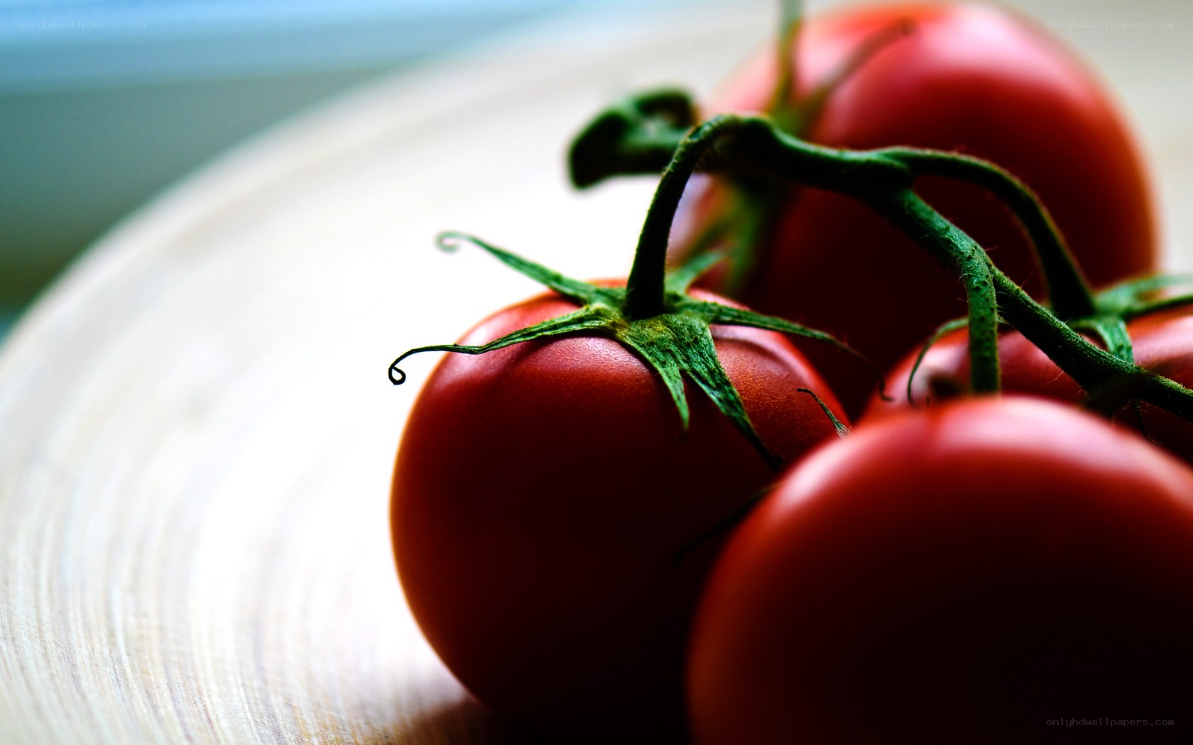 Fresh tomatoes on a wooden surface