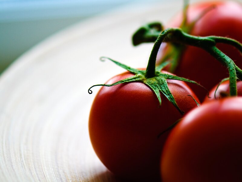 Fresh tomatoes on a wooden surface