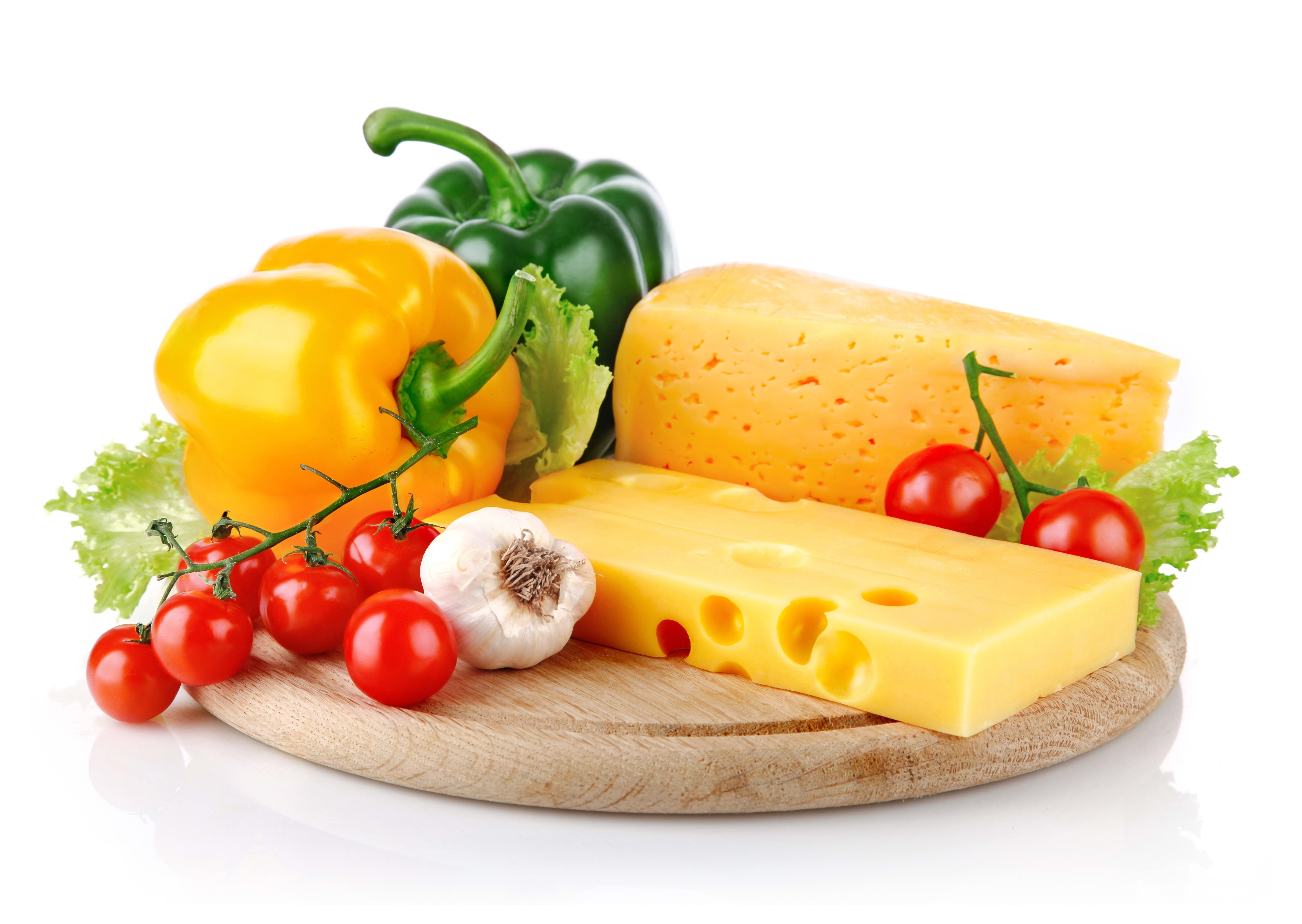 Fresh vegetables and cheese on board